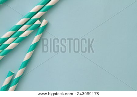 Group Of Cardboard Tubes For Cocktails With Blue Striped Straws On A Skyey Table. Selected Focus. To