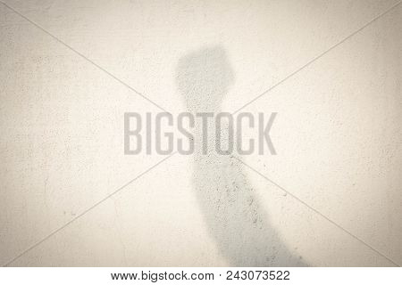 Shadow Of Human Hand On Abstract Wall
