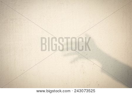 Shadow Of Human Hand On Abstract Wall