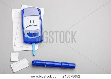 Diabetes Mellitus, Increased Blood Sugar Levels. The Display Is A Sad Face. Gray Background. Copy Sp