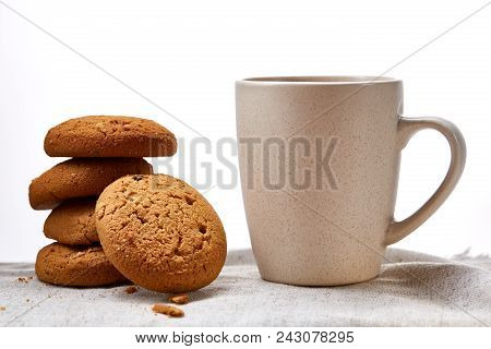 White Porcelain Mug Of Black Tea Or Earl Grey And Pile Of Sweet Cookies On Homespun Napkin Over Whit