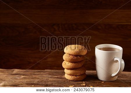 White Porcelain Mug Of Black Tea Or Earl Grey And Pile Of Sweet Cookies On Flat Piece Of Wood Over R