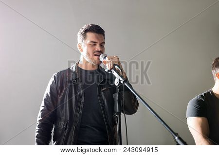 Lead Singer Of Rock And Roll Band Singing Live On Stage In A Music Concert