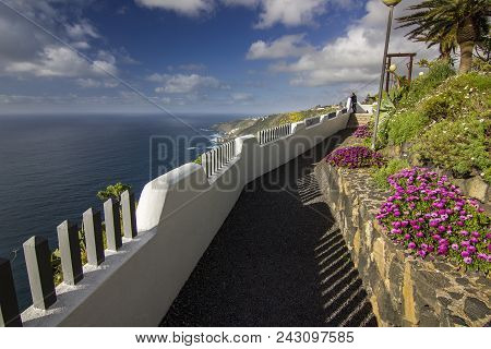 Path On Viepoint To Ocean With White Fence And Flowers