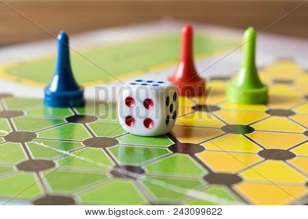 Multi-colored Game Chips With Dice On The Playing Board. Board Game.
