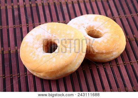 Homemade Doughnuts With Jelly Filled And Powdered Sugar On Bamboo Tablecloth. Selective Focus