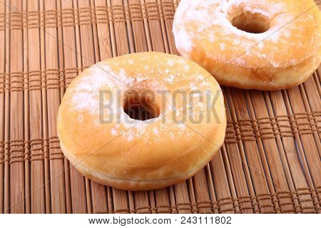 Homemade Doughnuts With Jelly Filled And Powdered Sugar On Bamboo Tablecloth. Selective Focus
