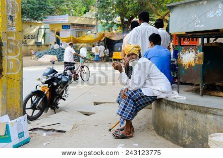 Old Indian Man Sits At The Street Market And Smokes Cigarette 11 February 2018 Puttaparthi, India