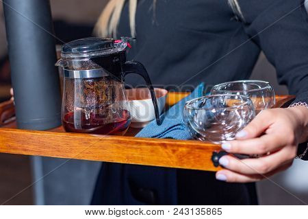 Tea Accessories In A Tray In Female Hands