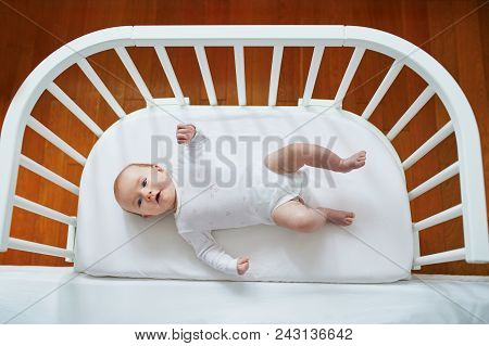 Baby Girl In Co-sleeper Attached To Parents' Bed