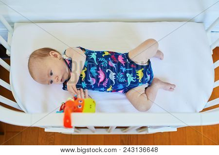 Baby Girl Lying In Co-sleeper Attached To Parents' Bed