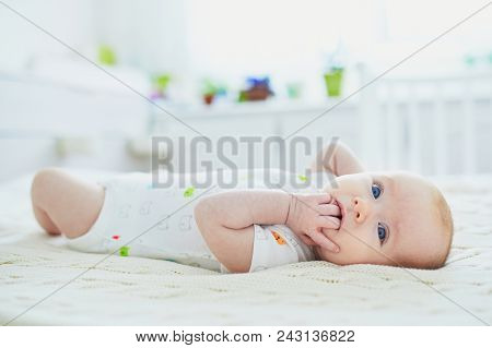 Baby Girl In Co-sleeper Attached To Parents' Bed