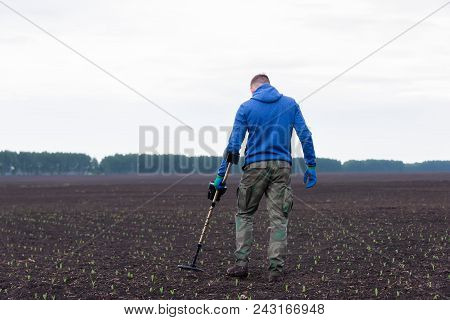 Man To Seek Treasure On Earth With A Metal Detector, Walks The Field, Squeak Gold