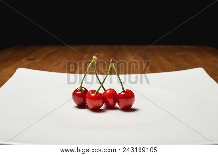 Fresh Cherry On Plate On Wooden Blue Background. Fresh Ripe Cherries. Sweet Cherries. Close Up