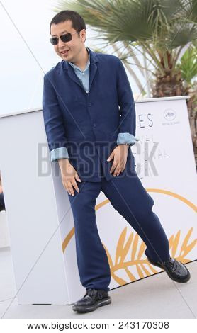 Jia Zhang-Ke waves at the photocall for 'Ash Is The Purest White (Jiang Hu Er Nv)' during the 71st annual Cannes Film Festival at Palais des Festivals on May 12, 2018 in Cannes, France.