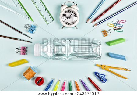 School Snack. Bottle Of Water And School Supplies On Blue Background. Back To School Concept.flat La