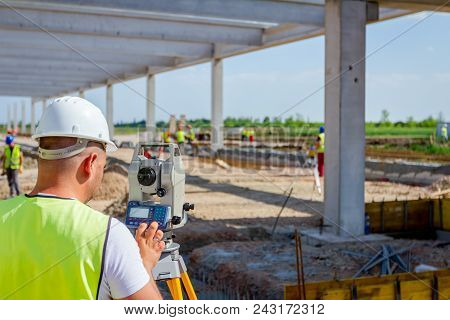 Surveyor Engineer Is Measuring Level On Construction Site. Surveyors Ensure Precise Measurements Bef