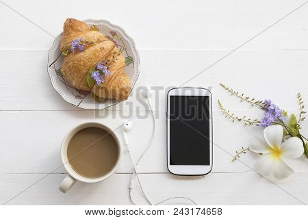 Hot Coffe With Dessert Bakery And Mobile Phone On Background White Wooden