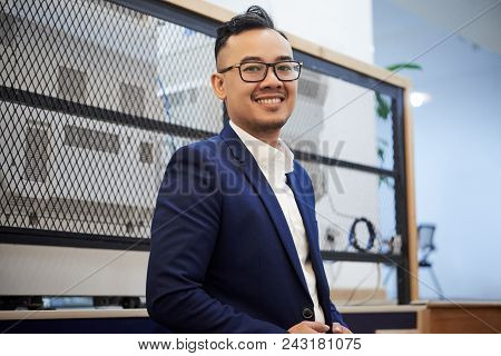 Portrait Of Happy Handsome Young Businessman In His Office