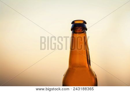 Empty Yellow Beer Bottle On Isolated Background