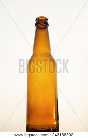 Empty Yellow Beer Bottle On Isolated Background
