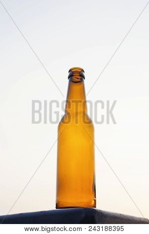 Empty Yellow Beer Bottle On Isolated Background