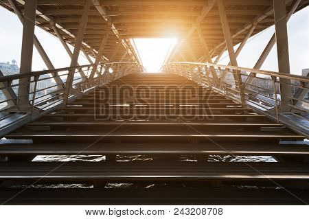 Stairs Of Solferino Pedestrian Bridge Over River Seine Against Sun In Paris, France