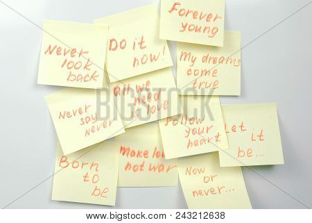 Yellow Sticker Paper Sheets With Motivation Phrases On A White Board
