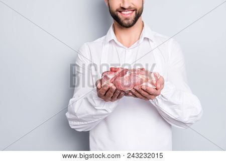 Close Up Cropped Portrait Of Cheerful Half Face Butcher Demonstrate Fresh Meat In His Arms,  Isolate