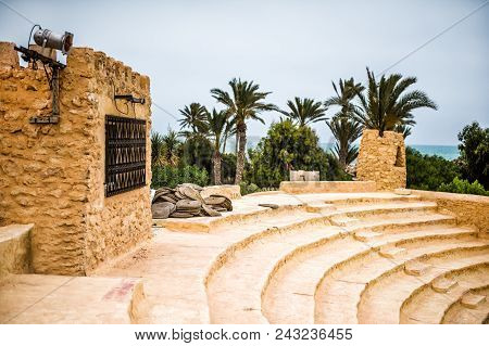 Classic Ancient Amphitheater In An Arab Town With Wicker Seats And Clay Steps