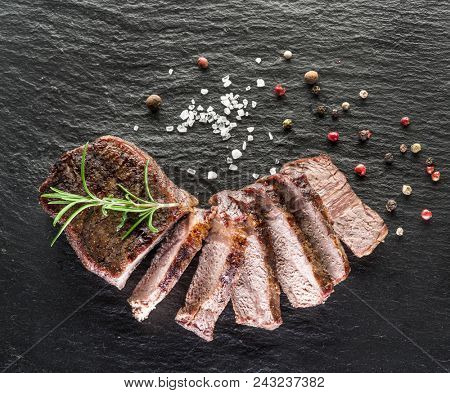 Steak Ribeye with spices on the wooden tray.