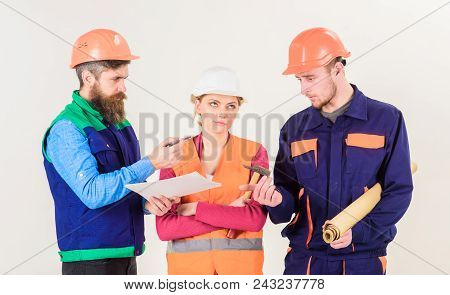 Inspector Chastises Employee, Builder. Men And Woman In Helmets On Bored Face With Tools And Documen
