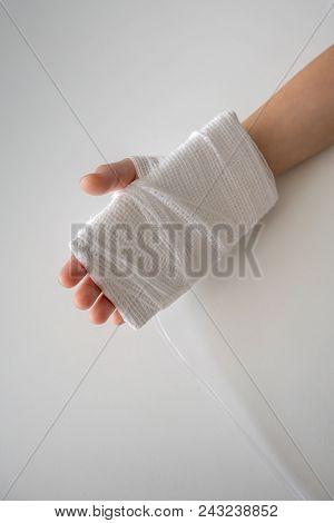 Kid Hand With An Elastic Bandage  With The Tube Of Normal Saline Infusion.