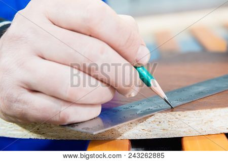 Close-up Of The Hand Of The Carpenter's Master Is Marked With A Ruler And A Pencil Blank. The Concep