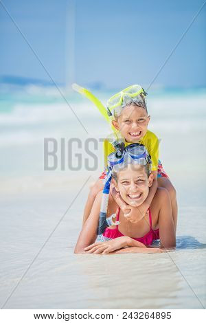 Brother And Sister Playing And Having Fun On The Beach During The Hot Summer Vacation Day.