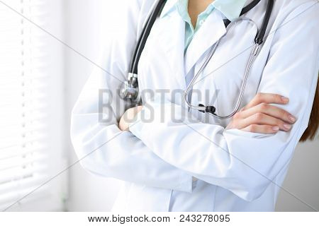 Woman Doctor At Work In Hospital Office, Closeup. Portrait Of Female Physician With Arms Crossed. Me