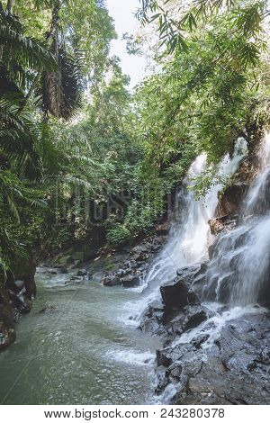 Scenic View Of Beautiful Kanto Lampo Waterfall, Green Plants And Rocks, Bali, Indonesia