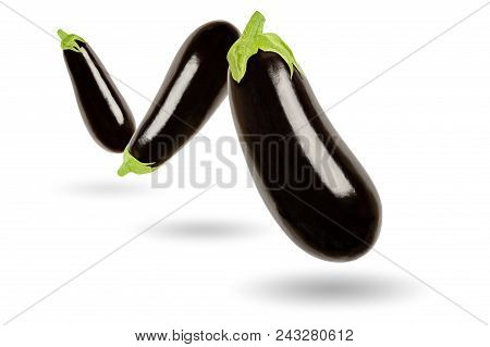 Three Eggplants In A Row Floating In The Air, On White Background. Solanum Melongena, Also Called Au