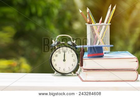 Graduate Or Education Knowledge Study Abroad Concept : Graduation Cap On Textbook With Pencil Box An