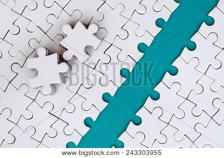 The Blue Path Is Laid On The Platform Of A White Folded Jigsaw Puzzle. The Missing Elements Of The P