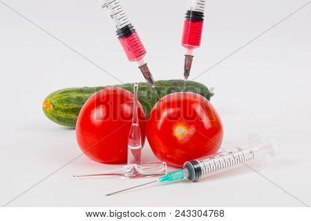 Tomatoes And Cucumber Vegetables And Syringe With Nitrates. Gmo Food Ingredient.