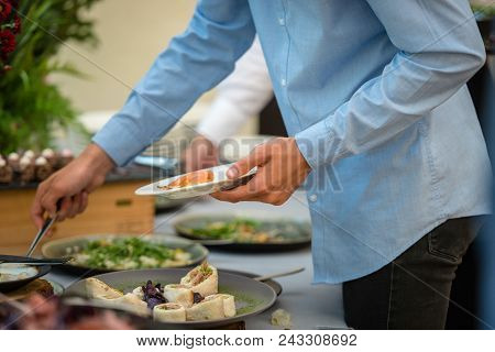 People At A Banquet Taking Different Food. Colleagues Buffet Party Brunch Dinning Concept
