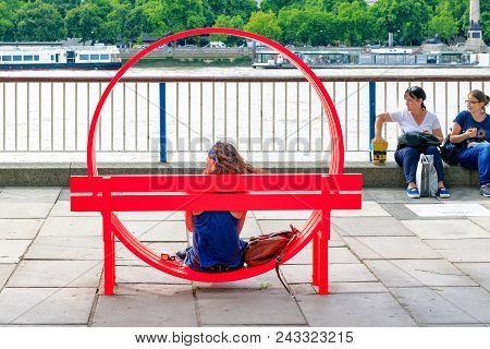 London, Uk - August 7, 2017 - Tourist Sitting On One Of Modified Social Benches By Jeppe Hein Displa