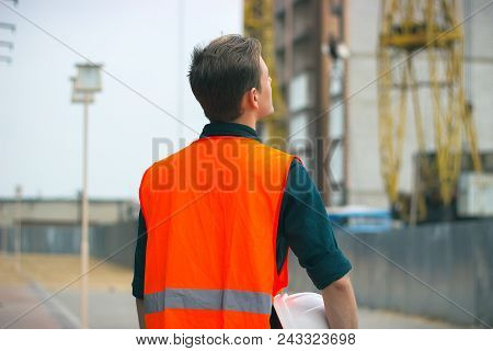 The Engineer Holding The White Helmet Safety At Construction Site With Crane Background Silhouette