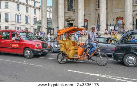 Charring Cross Road, London, England, Uk - April 22, 2018: Empty Rickshaw In Traffic Outside St. Mar
