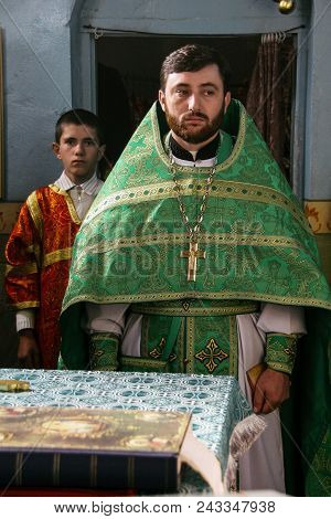 Voyutyn, Ukraine - 14 October 2008: Orthodox Priest And Sexton During Celebration Pokrov