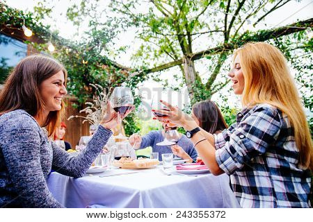 Friends Having Dinner In Garden