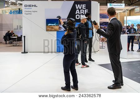 Berlin - April 26, 2018: Stand Of Diehl Aviation. The Visitor Will Test The Virtual Reality System. 