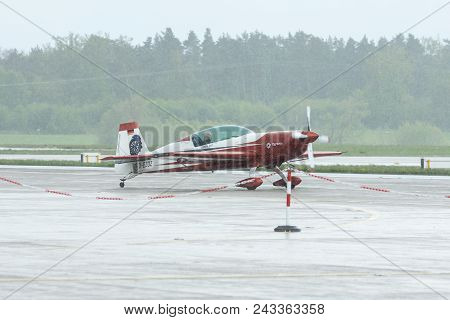 Berlin - April 26, 2018: Aerobatic Monoplane Extra Ea-300l On The Airfield Under Heavy Rain. Exhibit
