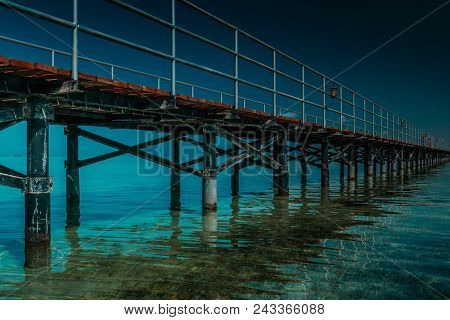 The Bridge Goes Into The Sea At Sunset
